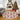 Decorative Christmas rug with festive design in a living room with a Christmas tree and fireplace.